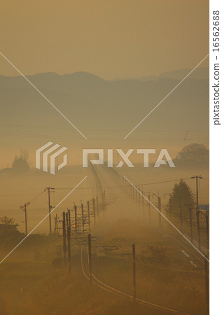 Railroad that disappears in the morning mist Railroad that disappears in the morning mist 16562688