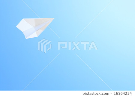 A paper plane dancing in a crystal clear blue sky 16564234