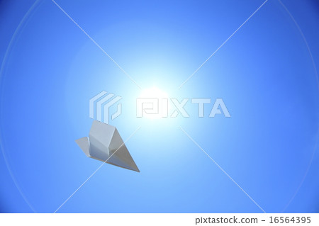 A paper plane dancing in a crystal clear blue sky A paper plane dancing in a crystal clear blue sky 16564395