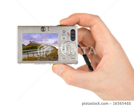 Hand with camera and Norway travel photo Hand with camera and Norway travel photo 16565488