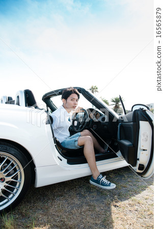 A man riding an open car 16565879