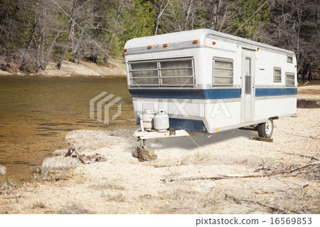 Classic Old Camper Trailer Near A River Classic Old Camper Trailer Near A River 16569853