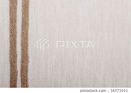 Jute ribbon on linen cloth background 16571031