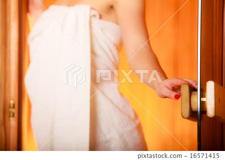 woman relaxing in wooden sauna room woman relaxing in wooden sauna room 16571415