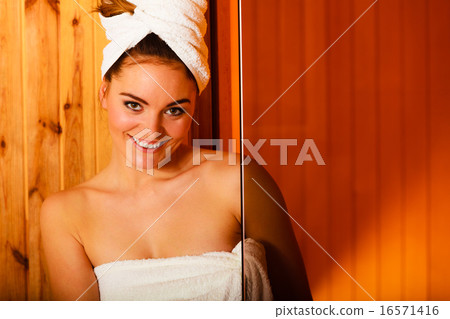 woman relaxing in wooden sauna room 16571416