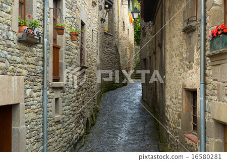 Narrow picturesque street of old Catalan town Narrow picturesque street of old Catalan town 16580281