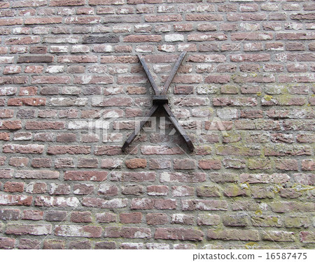 Very old cast iron cramp on brick wall. 16587475