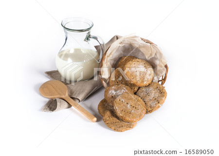 Rye finnish cookies with milk and wooden spoon 16589050