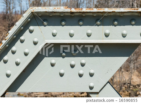 Angled steel girder with rivets on painted surface Angled steel girder with rivets on painted surface 16590855