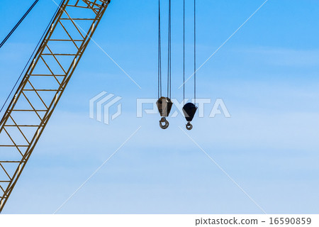 Pair of industrial crane hoists near truss. Pair of industrial crane hoists near truss. 16590859