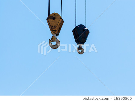 Pair of hanging industrial crane hoists on sky. Pair of hanging industrial crane hoists on sky. 16590860
