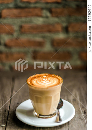 Cup of coffee with tree leaves pattern 16592642