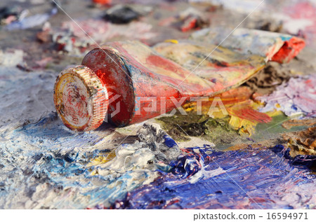 Closeup of old oil paint tube with red colour  16594971