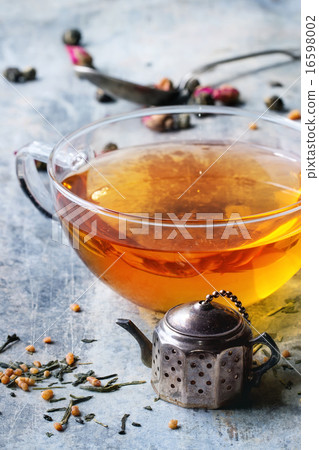 Cup of hot tea with tea strainer 16598002