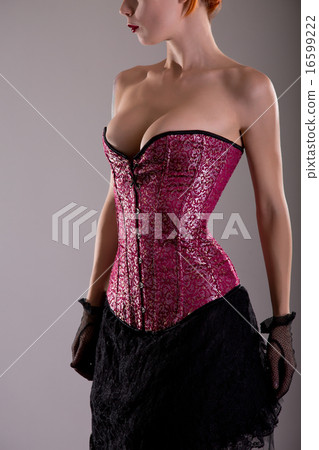 Busty young woman in purple corset 16599222