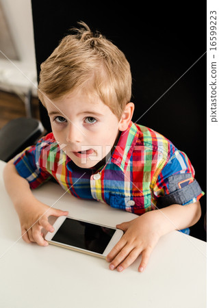 Little boy plays with smartphone Little boy plays with smartphone 16599223