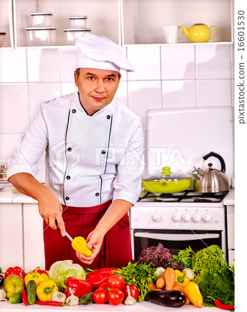 Man in chef hat cooking chicken Man in chef hat cooking chicken 16601530