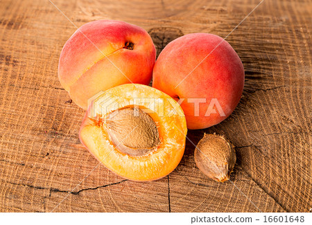 Apricots on the wooden background 16601648