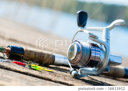 fishing rod on jetty close to lake fishing rod on jetty close to lake 16613912