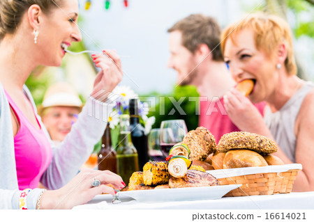 Friends eating bbq sausage and meat Friends eating bbq sausage and meat 16614021