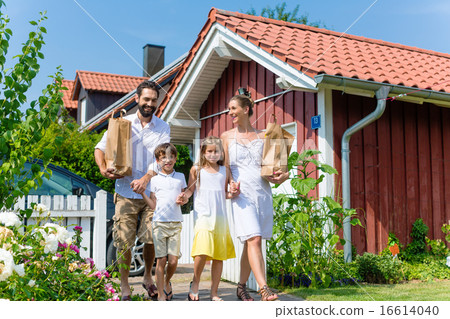 Family carrying groceries from car to house Family carrying groceries from car to house 16614040