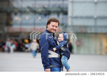 Father and his baby boy in a baby carrier Father and his baby boy in a baby carrier 16614910