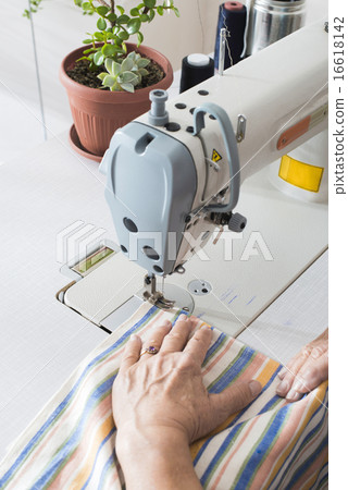 Women sew on sewing machine 16618142
