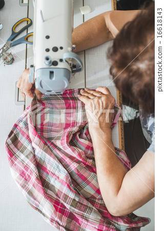 Women sew on sewing machine 16618143