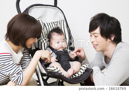 Baby riding a stroller, dad and mama 16618769