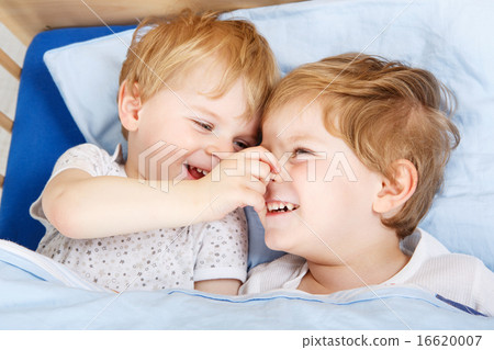 little sibling boys having fun in bed at home little sibling boys having fun in bed at home 16620007