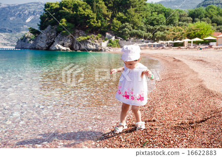 Little girl first time on the beach 16622883