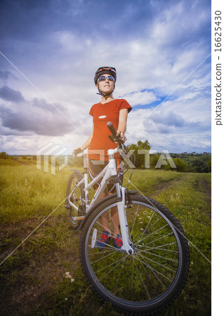 Woman is riding bicycle outside Woman is riding bicycle outside 16625430