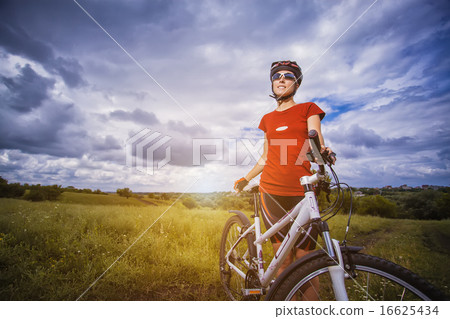 Woman is riding bicycle outside Woman is riding bicycle outside 16625434