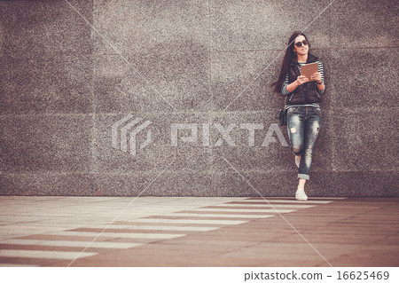 girl with tablet is walking in the downtown girl with tablet is walking in the downtown 16625469