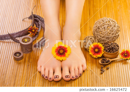 Relaxing pedicure with a orange flower 16625472