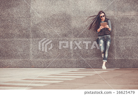 girl with tablet is walking in the downtown girl with tablet is walking in the downtown 16625479