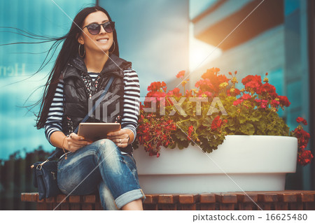 girl with tablet is walking in the downtown girl with tablet is walking in the downtown 16625480