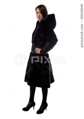 Young woman in fur coat with hands on hips 16626646