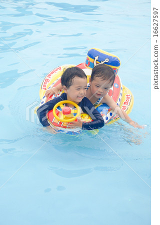 Boys playing in the pool 16627597
