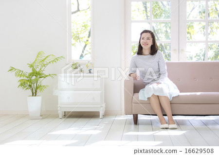 Woman sitting on the couch 16629508