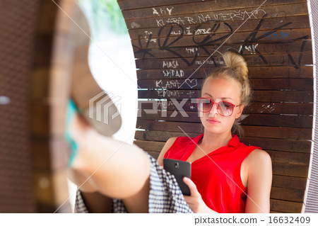Young cheerful woman using smarthphone. 16632409