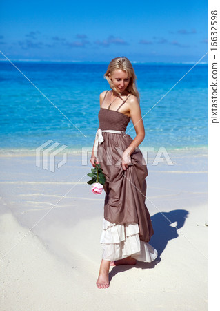 beautiful woman with a rose near the sea, tropics beautiful woman with a rose near the sea, tropics 16632598