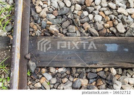 train track, spike, and wooden railroad tie. 16632712