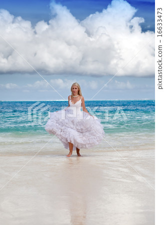 woman in a dress of the bride runs on waves of the woman in a dress of the bride runs on waves of the 16633473