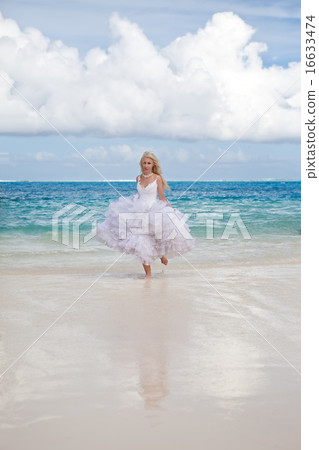 woman in a dress of the bride runs on waves of the woman in a dress of the bride runs on waves of the 16633474