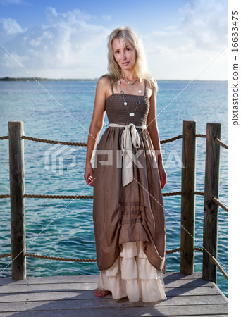 young beautiful woman  on a wooden platform over   16633475
