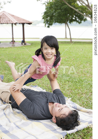 Young father and daughter playing in a park. Young father and daughter playing in a park. 16634828