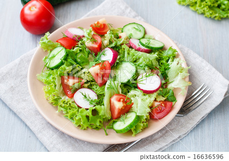 Tomato and cucumber salad with lettuce leafes Tomato and cucumber salad with lettuce leafes 16636596