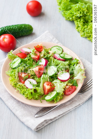 Tomato and cucumber salad with lettuce leafes Tomato and cucumber salad with lettuce leafes 16636597
