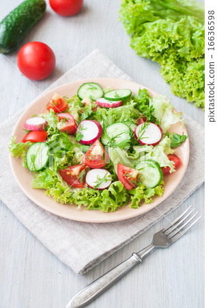 Tomato and cucumber salad with lettuce leafes Tomato and cucumber salad with lettuce leafes 16636598